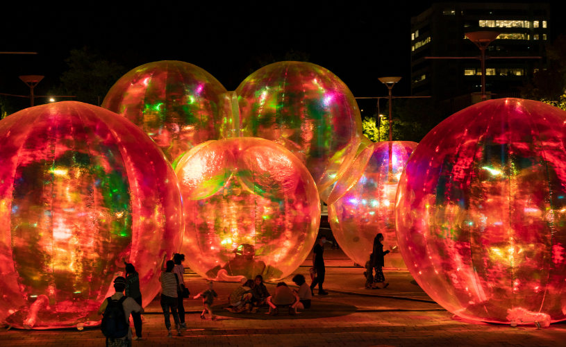 People in light up balls